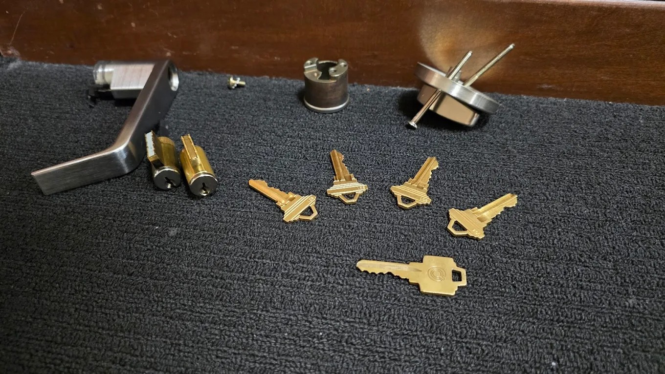 Professional locksmith using lock pick tools on residential deadbolt with stopwatch showing 8-minute service time